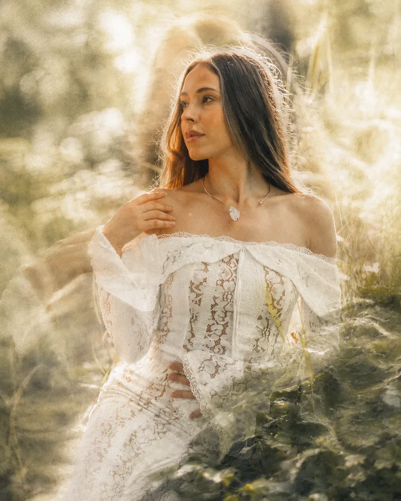 Mayra in the light among tall grass