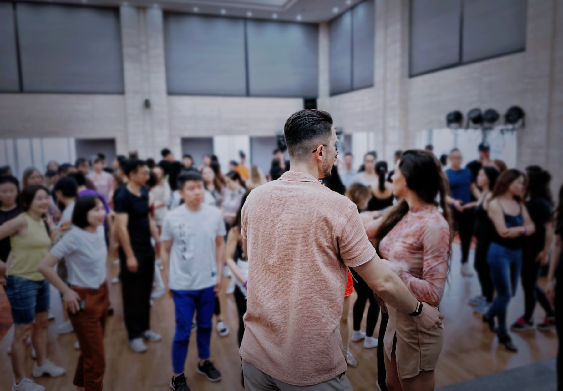 Michael and Mayra in front of a full room of dancers