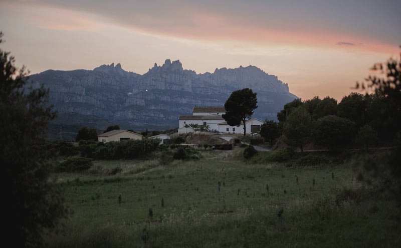 La Frasera farmhouse at dusk with Montserrat behind
