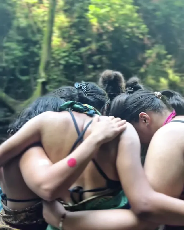 The group holding each other in a close circle