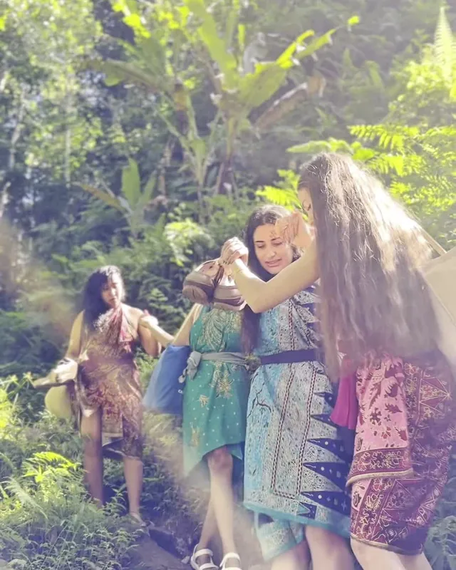 Women walking together and laughing on a jungle path