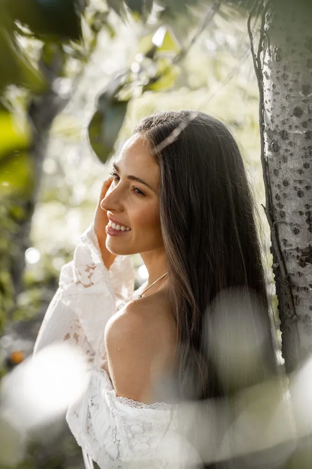 Mayra, smiling among the greenery