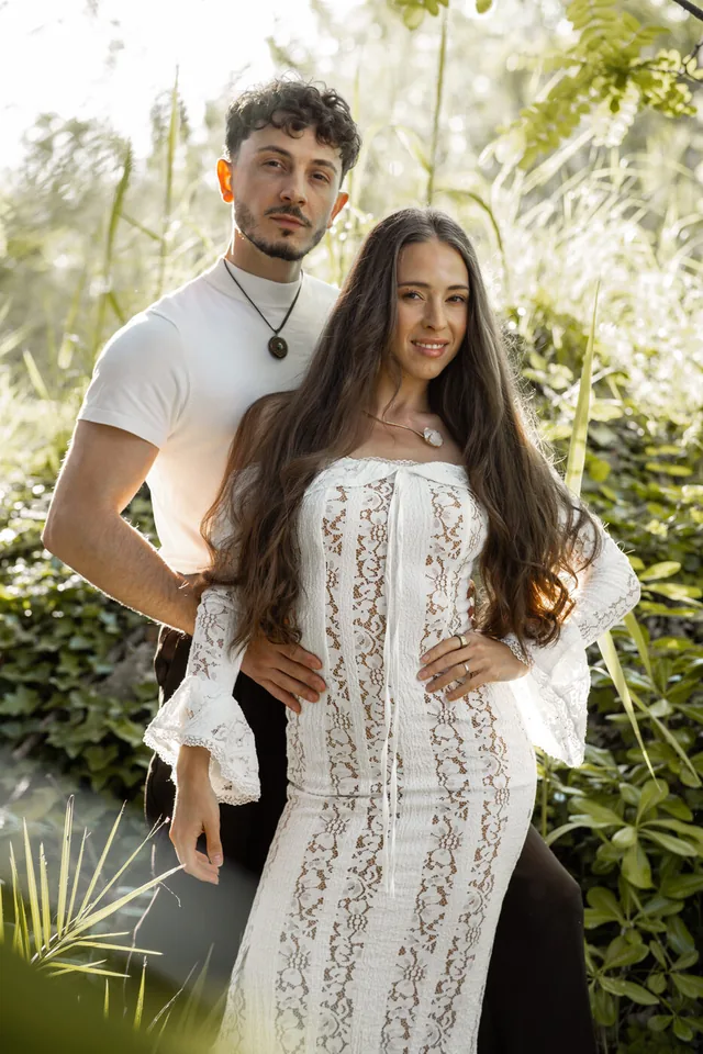 Michael and Mayra standing together in the forest